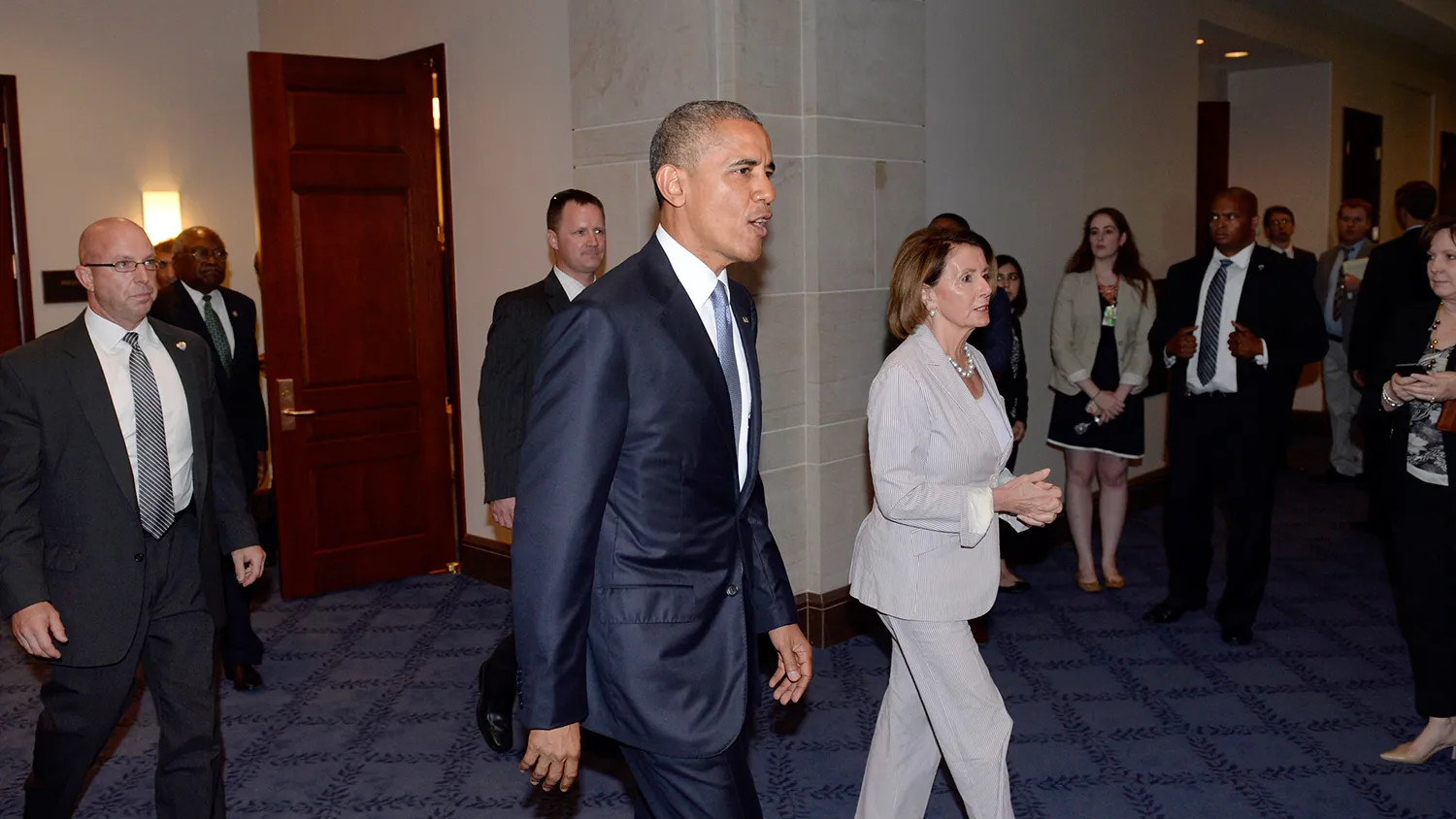 U.S. President Barack Obama and House Minority Leader Nancy Pelosi, a Democrat from California, right, leave the Gabriel Zimmerman room after a meeting with members of the House Democratic caucus to discuss Obama's trade agenda in Washington, D.C., U.S., on Friday, June 12, 2015.

