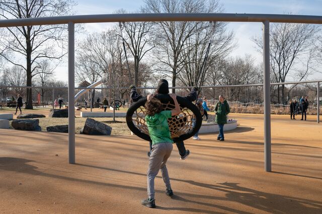 A child is pushed on a swing, part of the elliptical "megaswing."