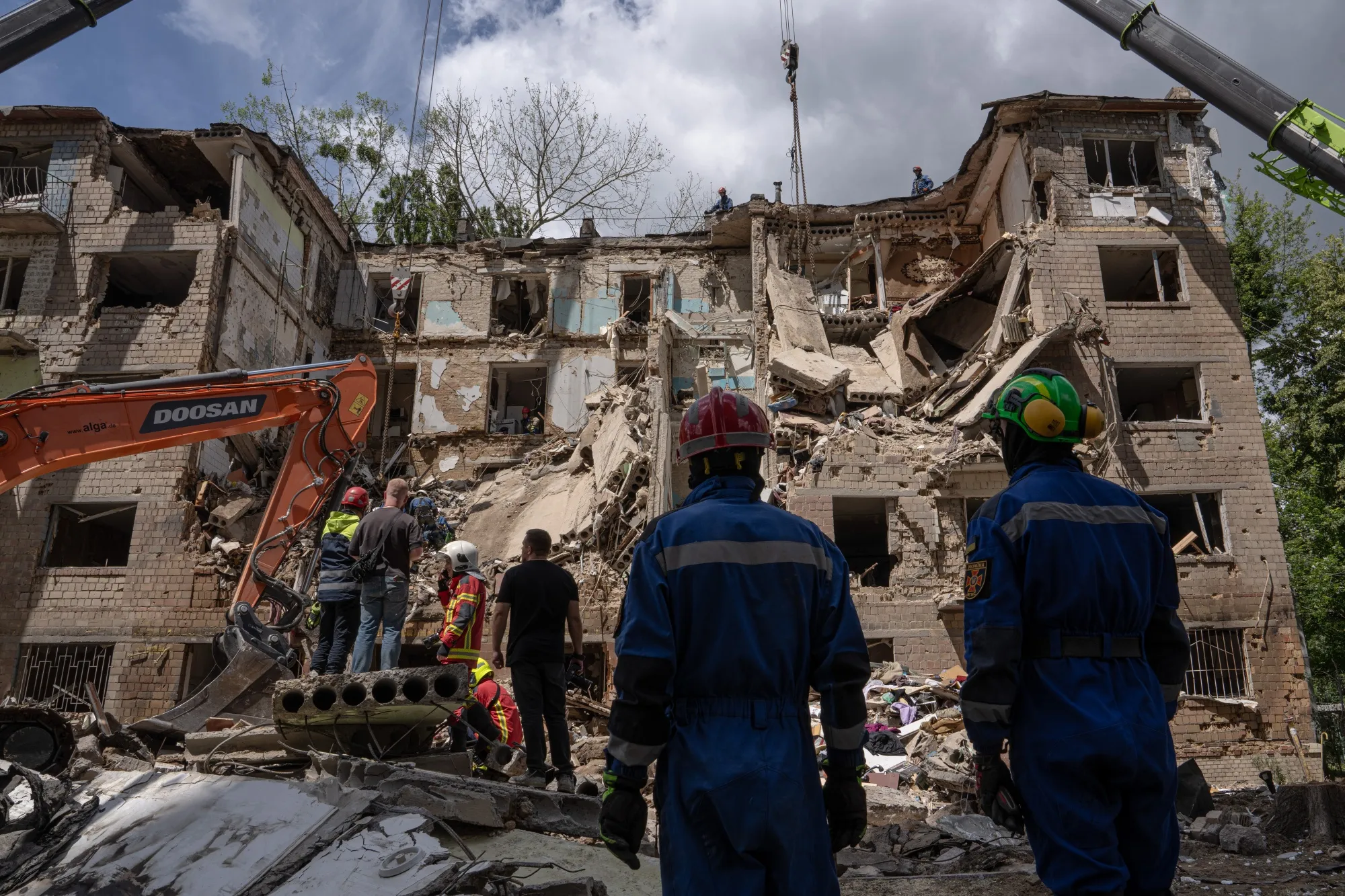 Rescue services search the site of a Russian air strike on a residential building in Kyiv, Ukraine, on&nbsp;June 23, 2025.
