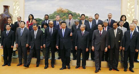 Chinese President Xi Jinping, center, and representatives of countries ready to join the Asian Infrastructure Investment Bank line up for a group photo at the Great Hall of the People in Beijing.