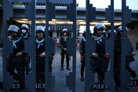 Riot police stand guard at the entrance of Thailand's Parliament in Bangkok.