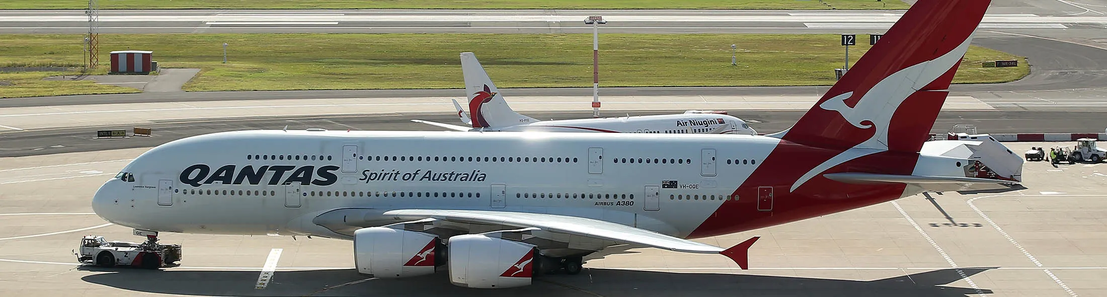 An Airbus SAS A380 aircraft operated by Qantas Airways Ltd., front, pushes back at Sydney Airport in Sydney, Australia, on Monday, Feb. 22, 2016. Qantas Airways is scheduled to announce half-year earnings on Feb. 23.
