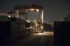 A gantry crane operates as containers sit stacked at the Yangshan Deepwater Port, operated by Shanghai International Port Group Co. (SIPG), at night in Shanghai, China on Wednesday, Jan. 30, 2019. The U.S. and China launched high-level trade talks in Washington with little indication that Beijing will bend to U.S. demands to deepen economic reforms.