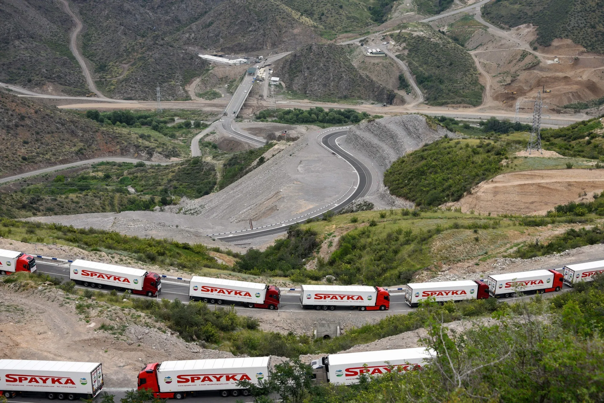 Armenian lorries carrying humanitarian aid for the Nagorno-Karabakh region seen stranded near an Azerbaijani checkpoint, in July.&nbsp;
