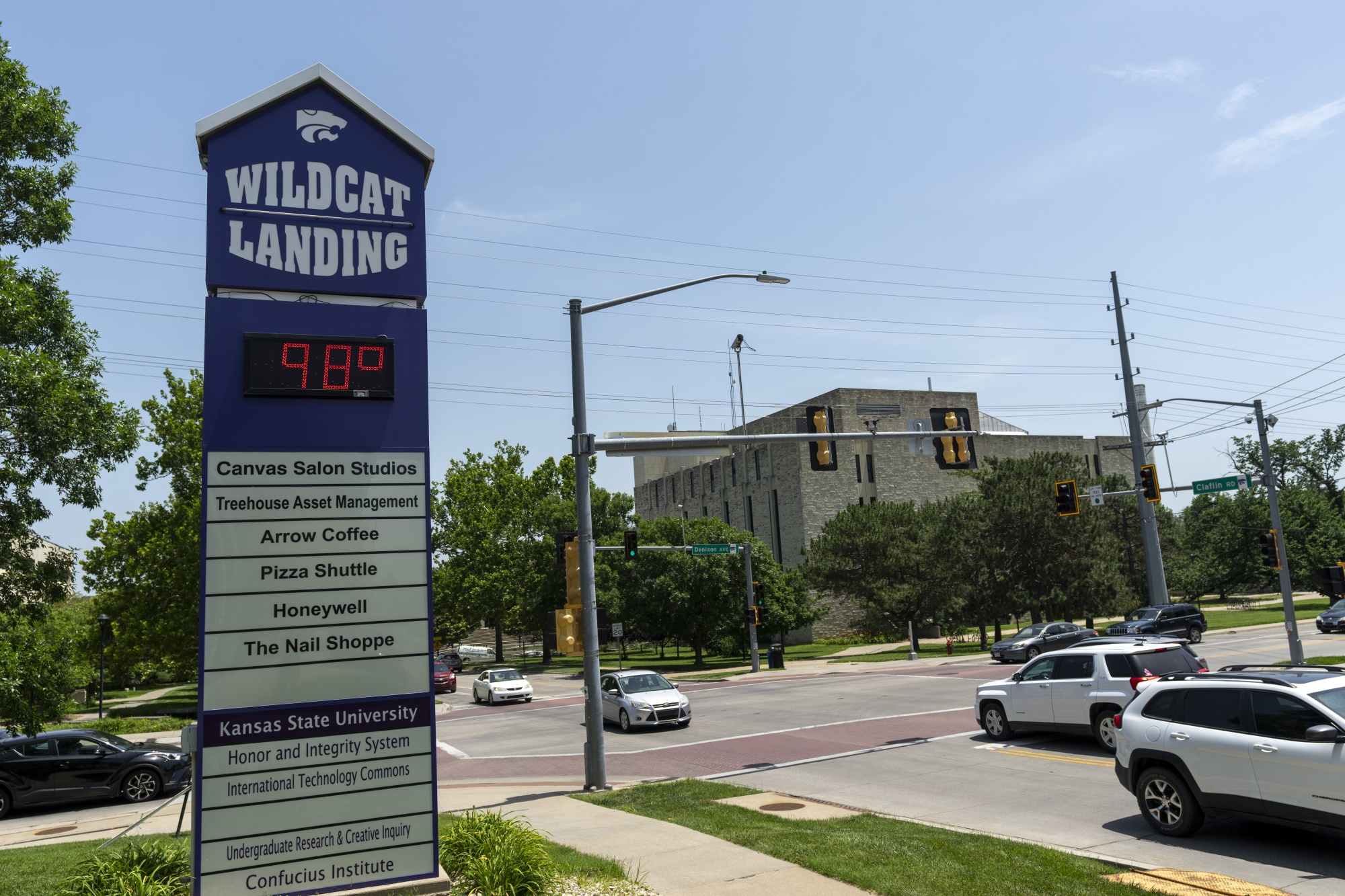 The temperature reads 98 degrees on signage in Manhattan, Kansas, in June 2022.