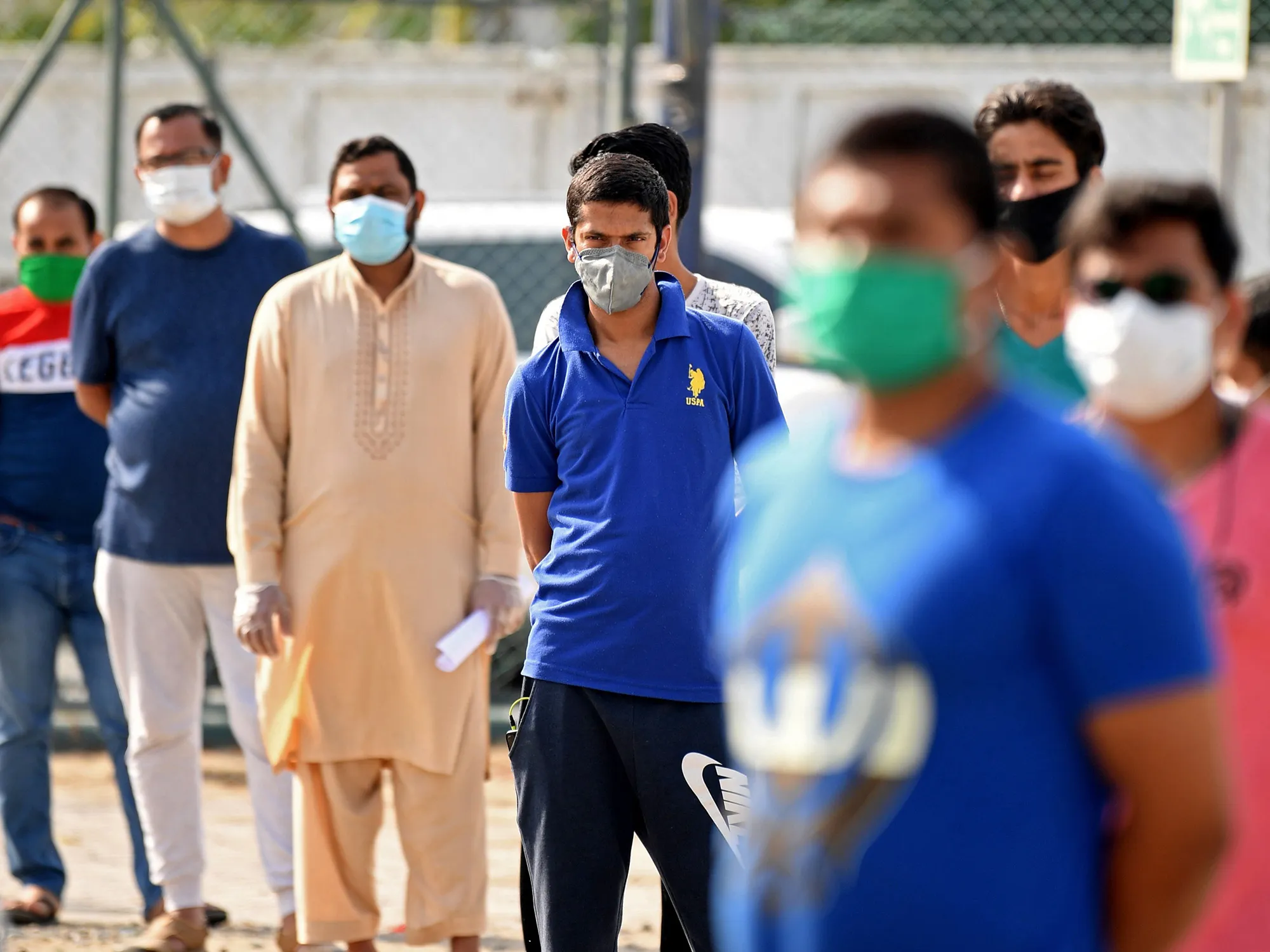 People wait at a coronavirus testing center in the Al Quaz area of Dubai,, on April 18.