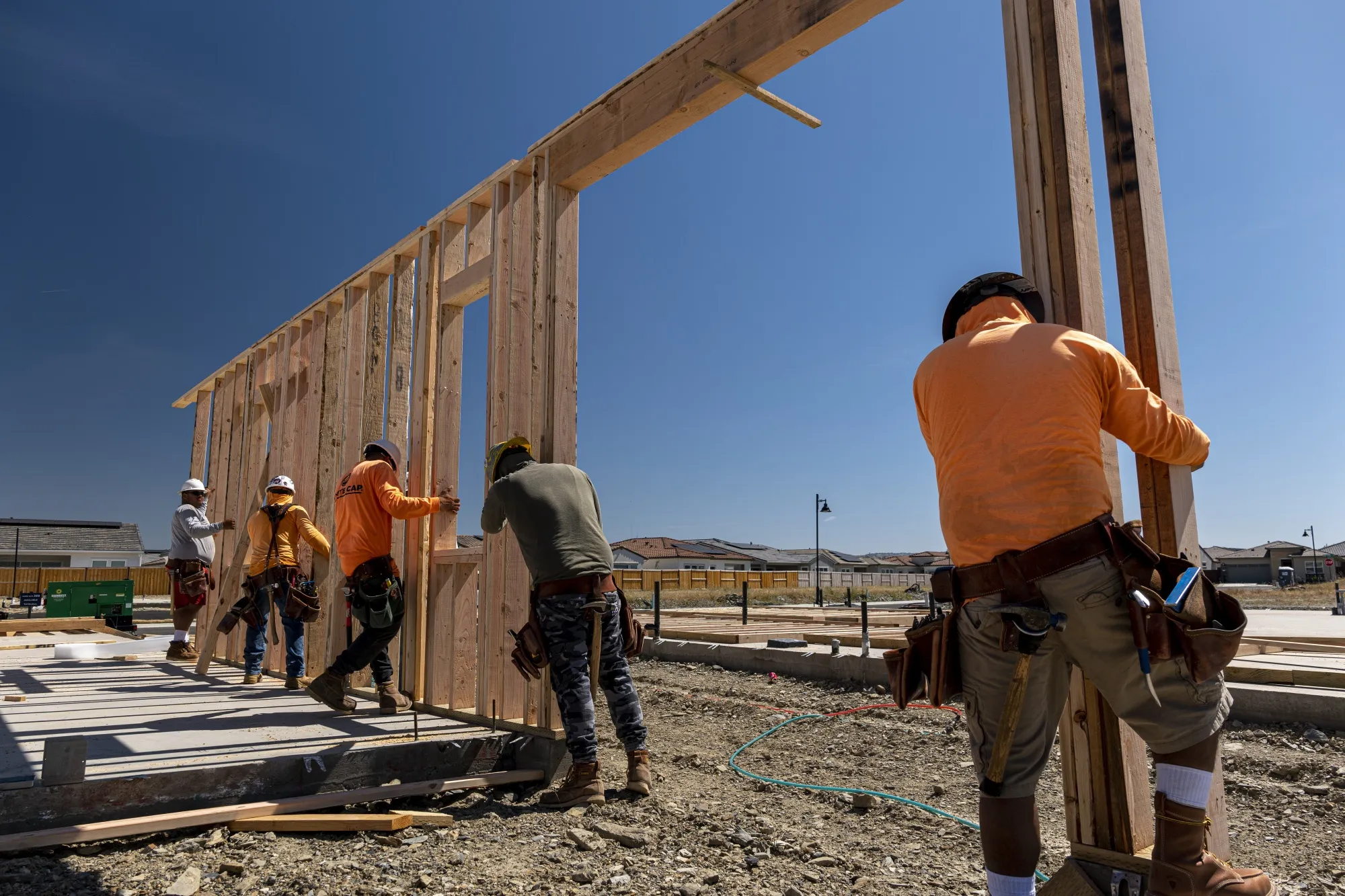 Contractors raise a framed wall on a house under construction&nbsp;in Folsom, California.