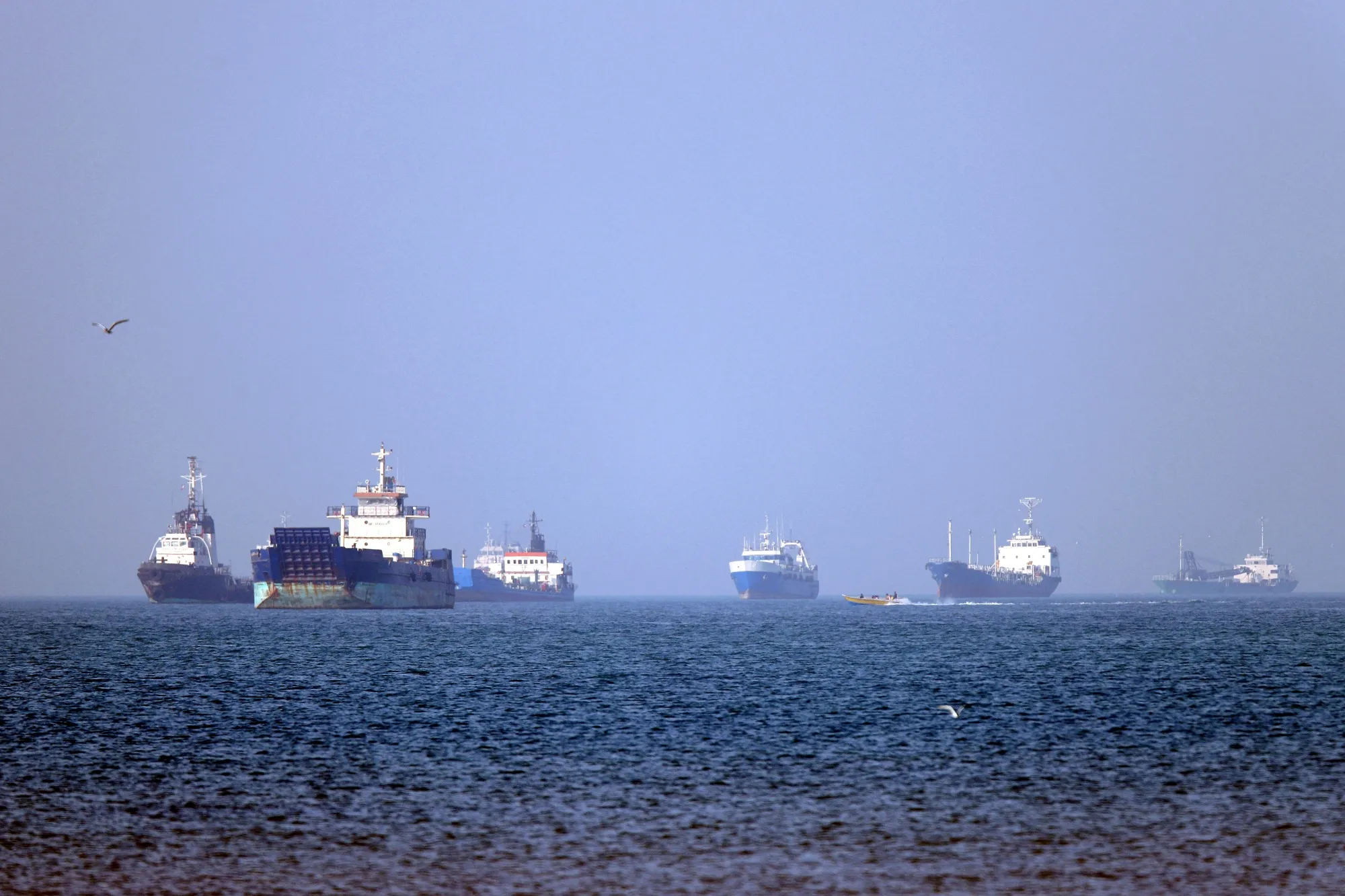 Vessels anchored in the Strait of Hormuz off Bandar Abbas in southern Iran. The waterway has been all but closed for two months.