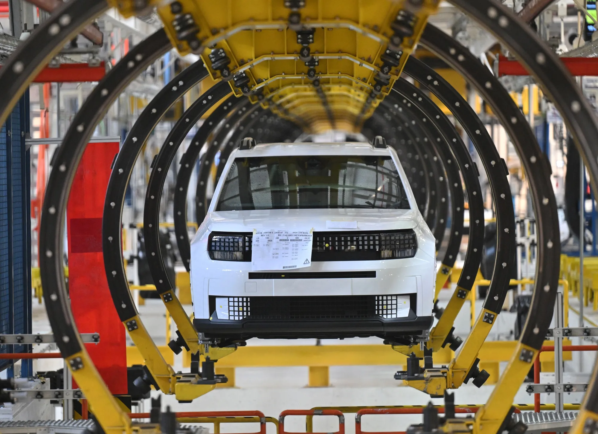 A new Fiat Grande Panda EV model automobile in a cradle on the production line at the Stellantis NV manufacturing plant.