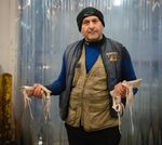 Sal Ruggiero, the “Calamari Kid,” holds squid at the New Fulton Fish Market in New York City’s Bronx.