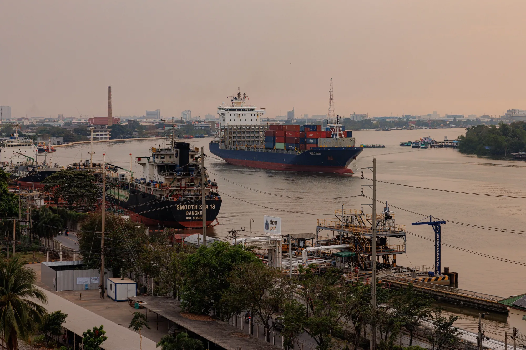 A container ship&nbsp;sails along the Chao Phraya river towards the Bangkok Port in Bangkok, Thailand.