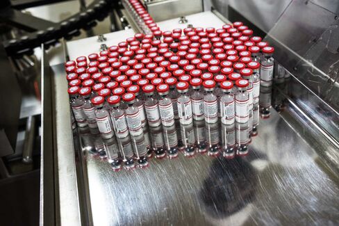 Vaccine vials exit a labeling machine at the Serum Institute of India Ltd. pharmaceutical plant in Pune, Maharashtra.