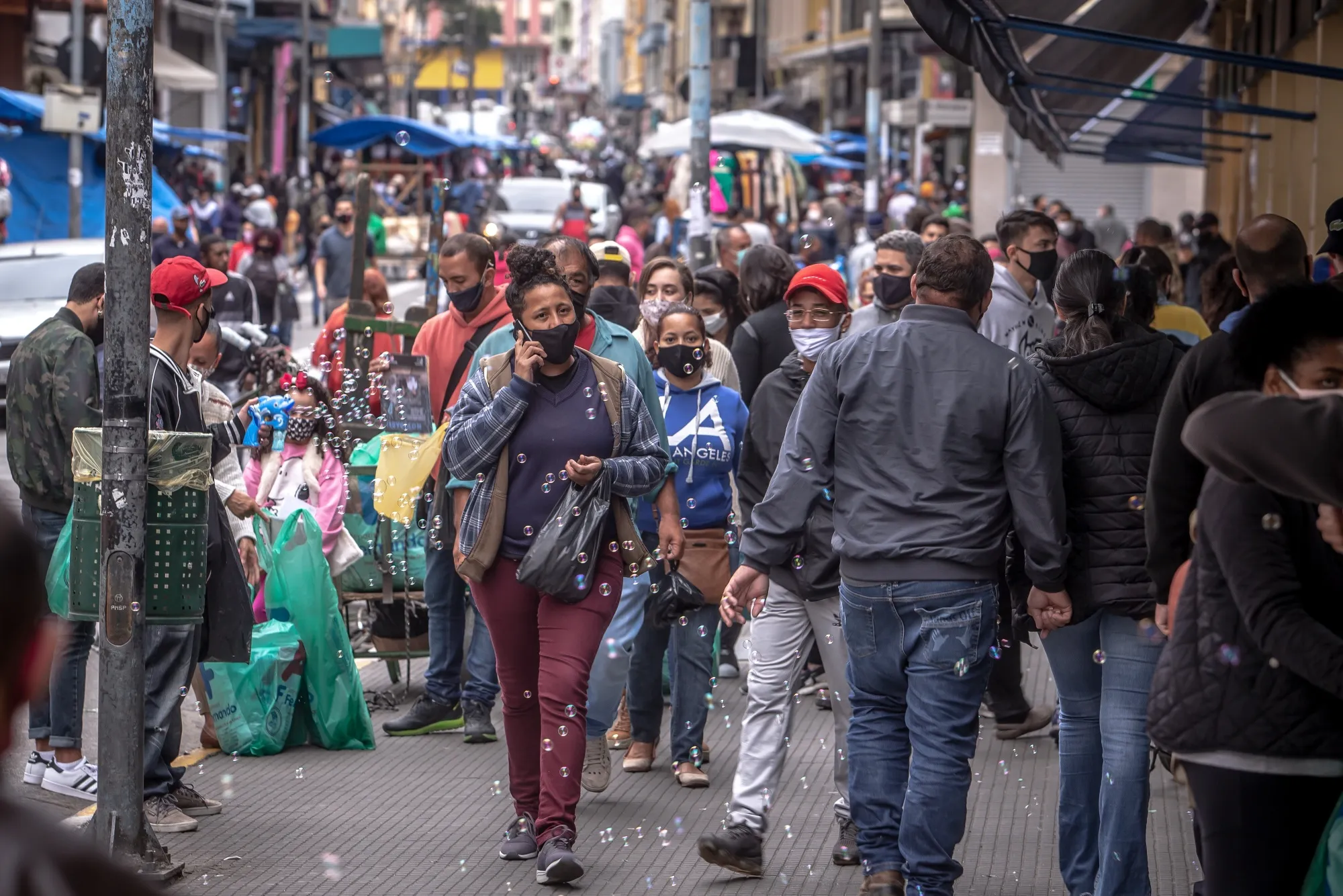 Pedestrians wearing protective masks walk along 25 de Marco street in Sao Paulo, Brazil, on&nbsp;July 30.