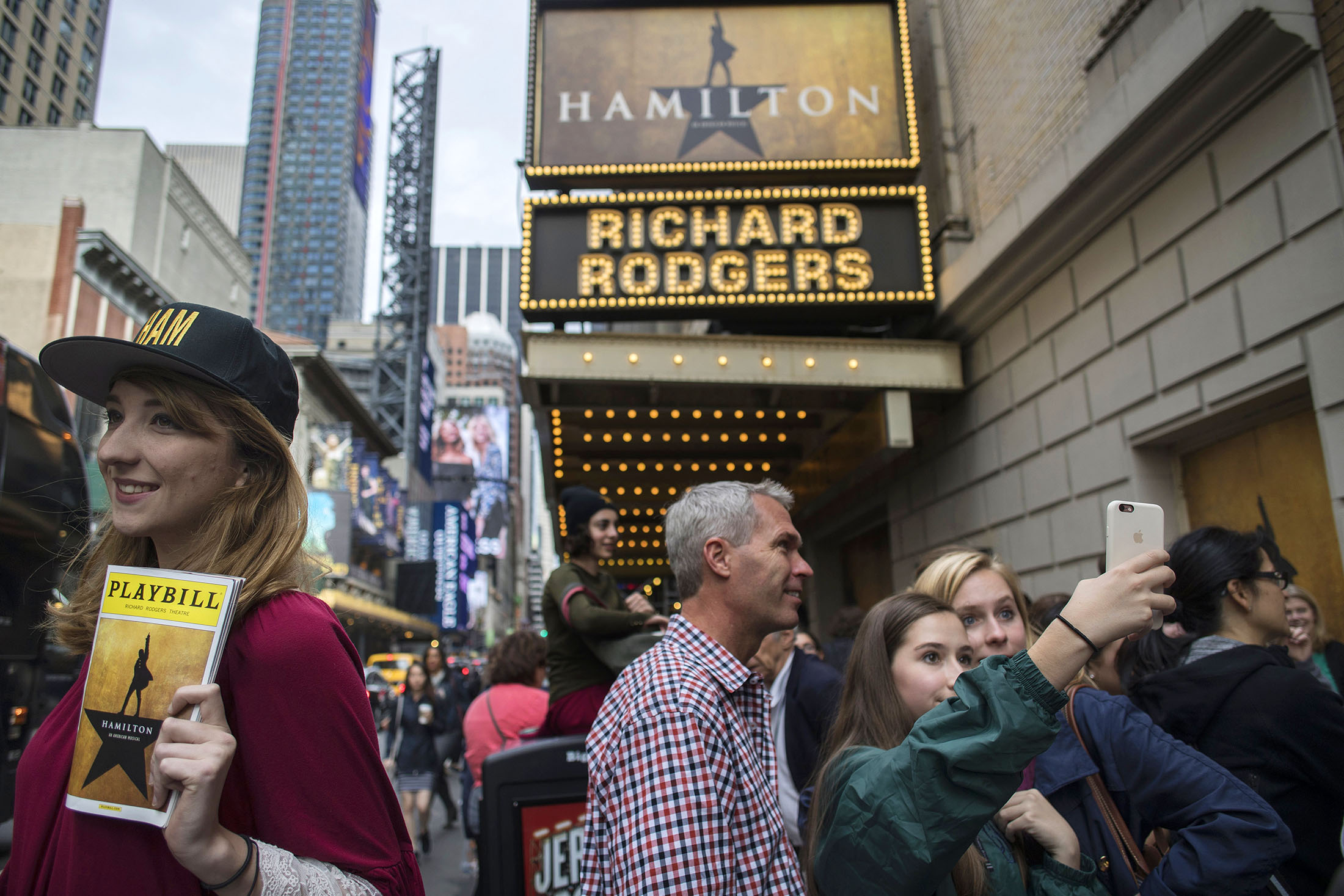 Attendees take photographs outside of the “Hamilton” musical in the Times Square area of New York on May 22.
