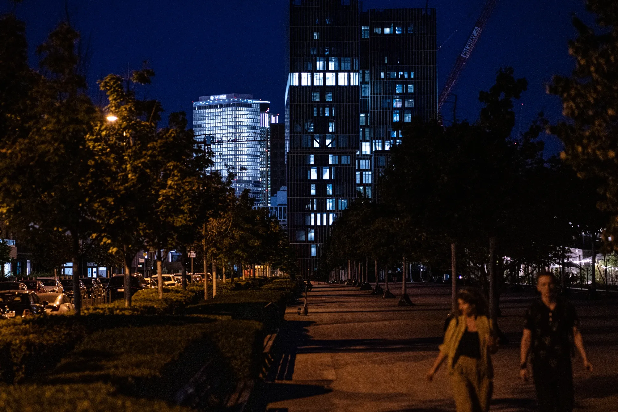 Partially lit commercial buildings at night in Frankfurt, Germany.