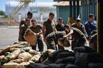 Brazilian soldiers pile humanitarian aid after unloading it from Brazilian Air Force plane, at Ala 7 air base in Boa Vista, Roraima state, Brazil in the border with Venezuela, on February 22, 2019.
