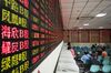 Investors stand at trading terminals in front of electronic stock boards at a securities brokerage in Shanghai, China, on Friday, Oct. 13, 2017. A number of economic indicators show \"stabilized and stronger growth\" and the momentum of a 6.9 percent expansion in the first six months of 2017 \"may continue in the second half,\" Peopleâs Bank of China Governor Zhou Xiaochuan said.