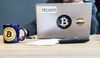 An employee uses a laptop computer branded with bitcoin logos inside the offices of La Maison du Bitcoin bank.