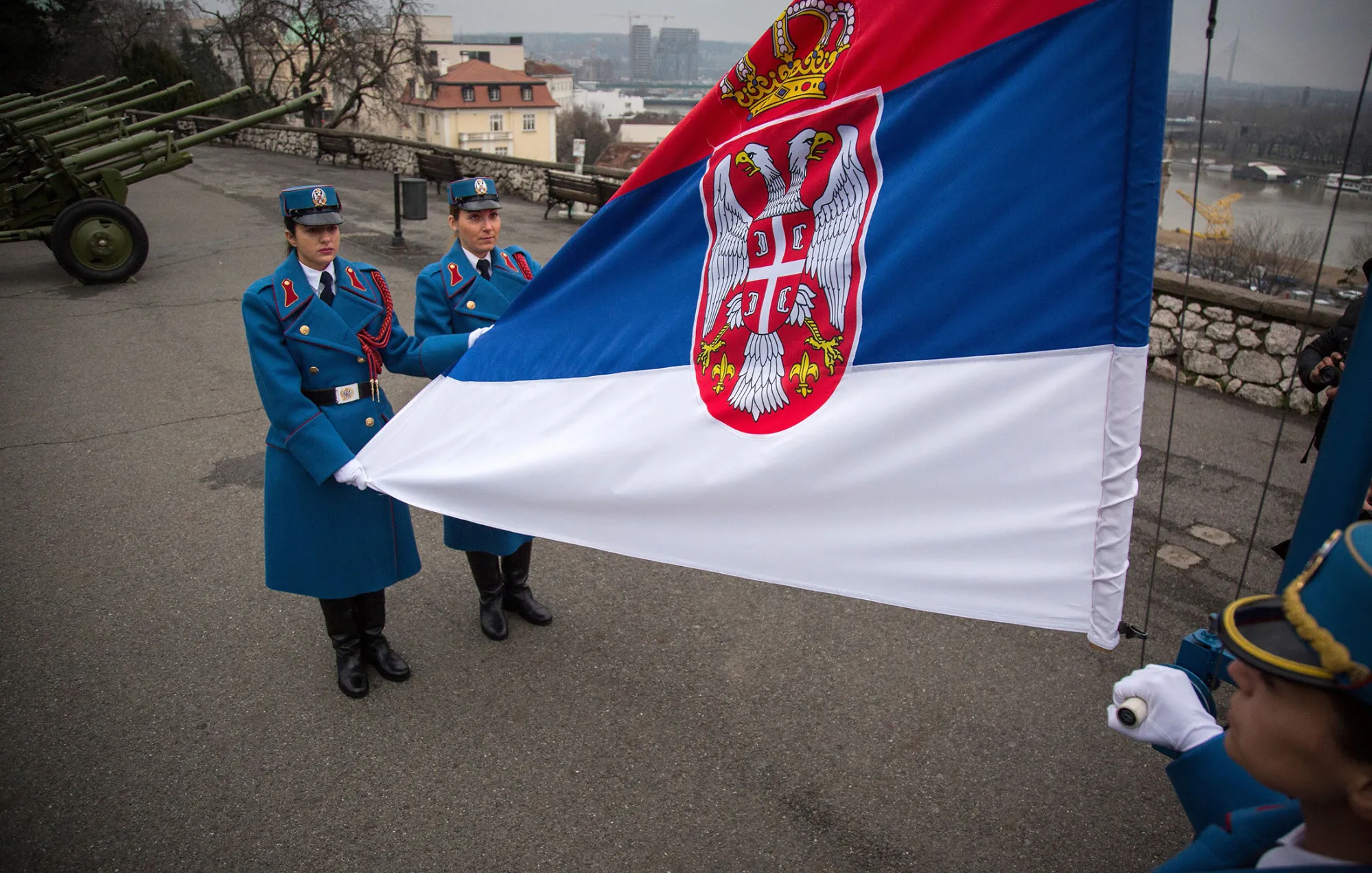 Serbian soldiers raise the national flag prior to an honour salute on the eve of Serbia's Statehood Day.
