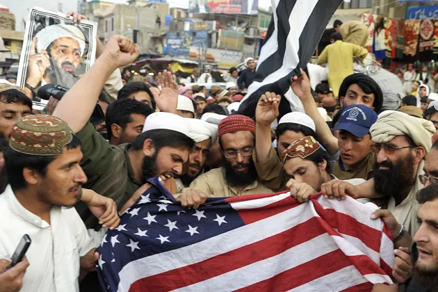 Supporters of a hardline pro-Taliban party burn a U.S. flag during an anti-U.S. rally in Quetta, Pakistan