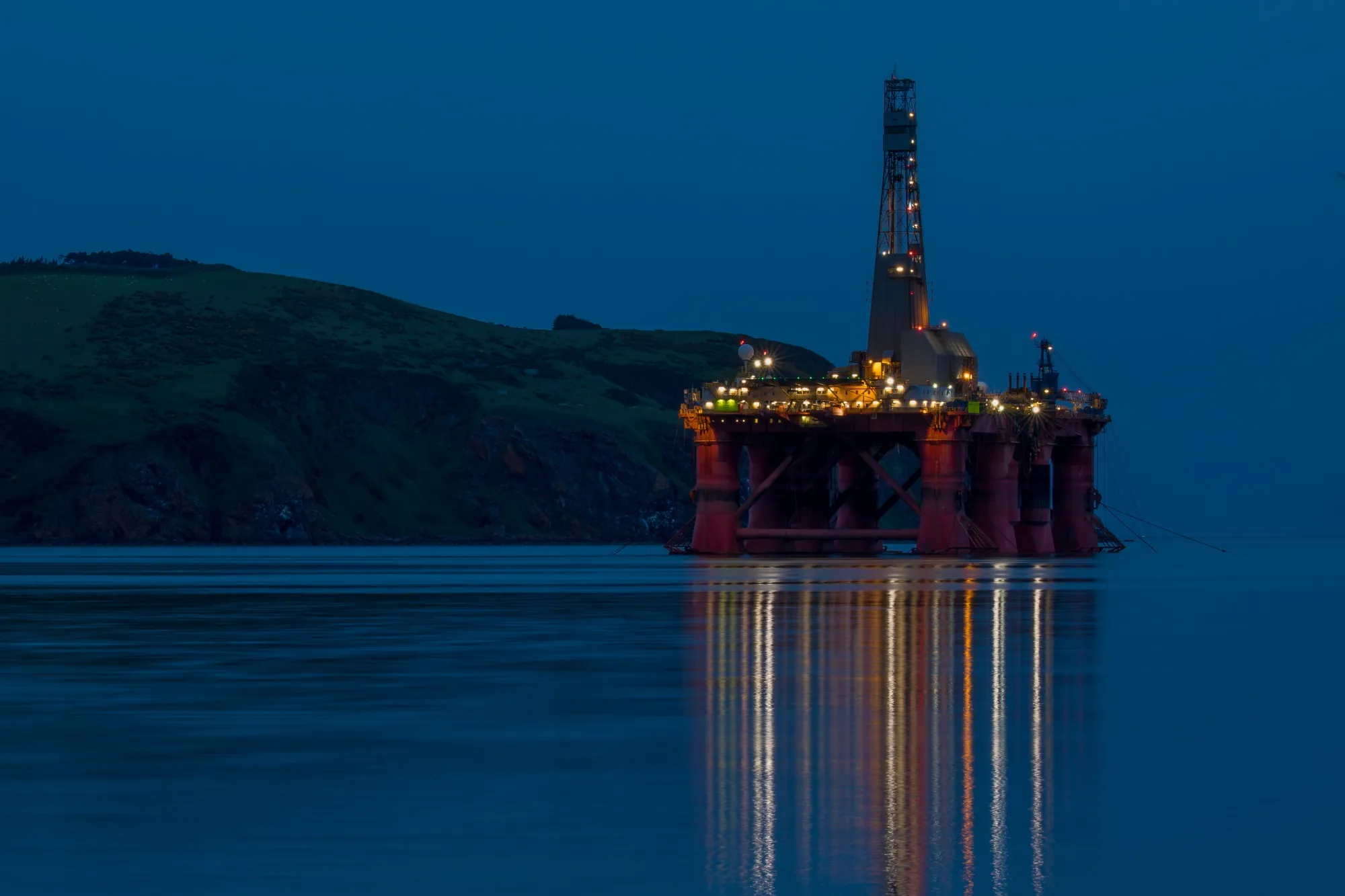 The Paul B. Loyd Jr drilling rig, operated by Transocean Inc., stands illuminated at night in the Port of Cromarty Firth in Cromarty, U.K.