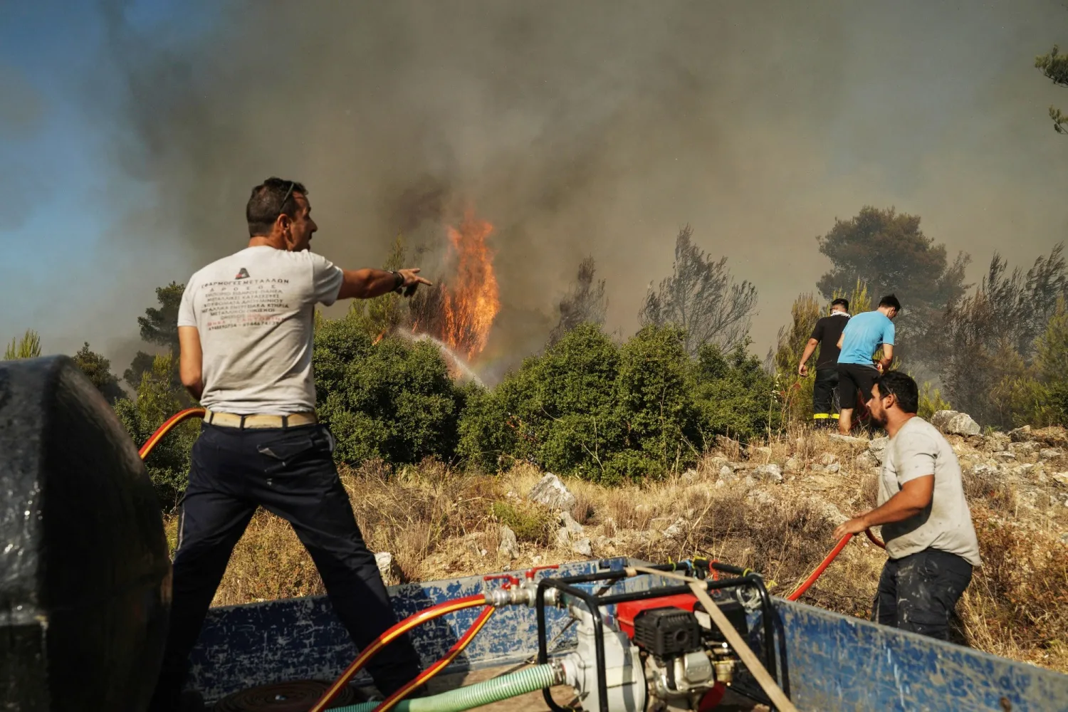 Volunteers work to extinguish a wildfire near Stamata, northeast of Athens, Greece, on June 30.