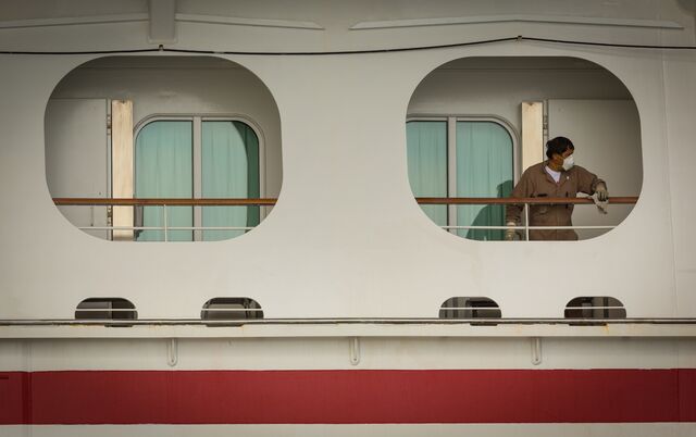 A worker cleans a docked Carnival cruise ship as the CDC extended its “No Sail Order” last April. 