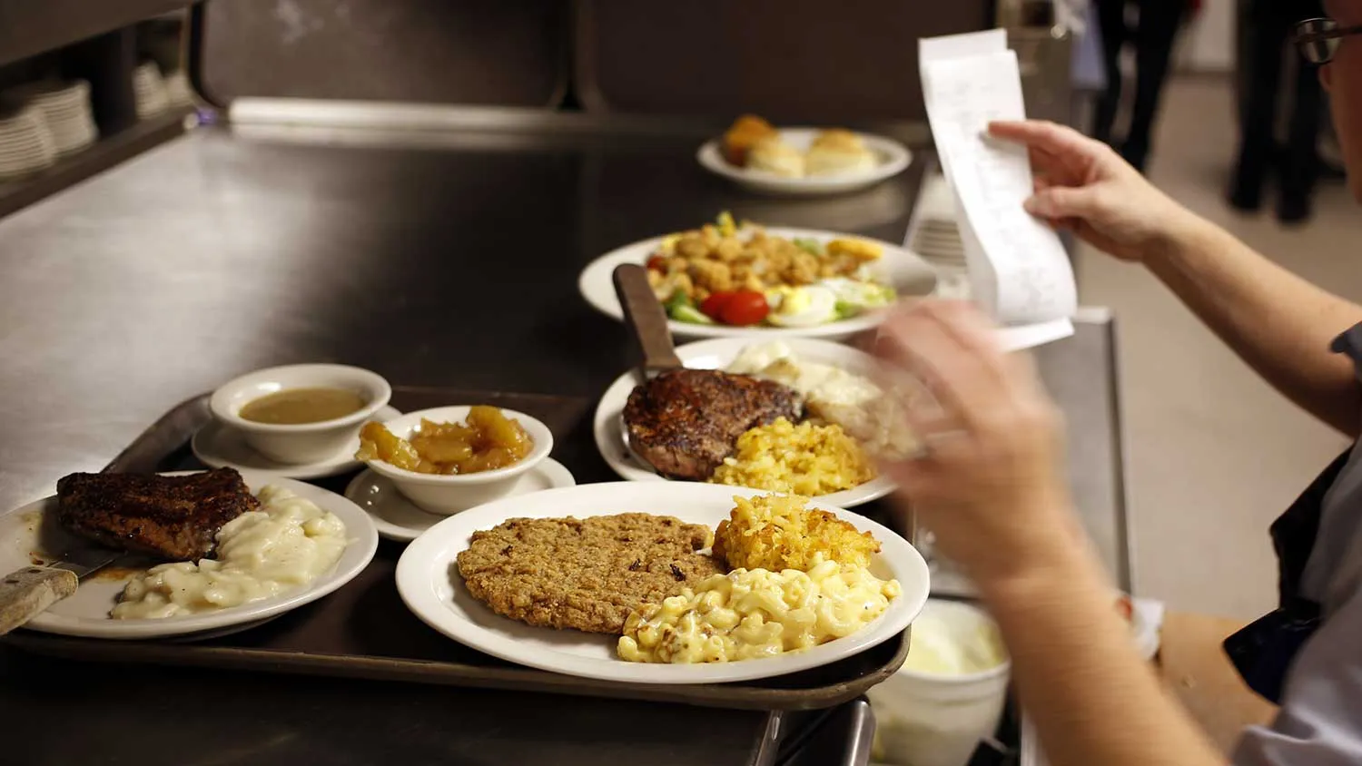 A waitress prepares to pick up an order during lunch hour at a Cracker Barrel Old Country Store and Restaurant in Frankfort, Kentucky, U.S., on Monday, Sept. 16, 2013.
