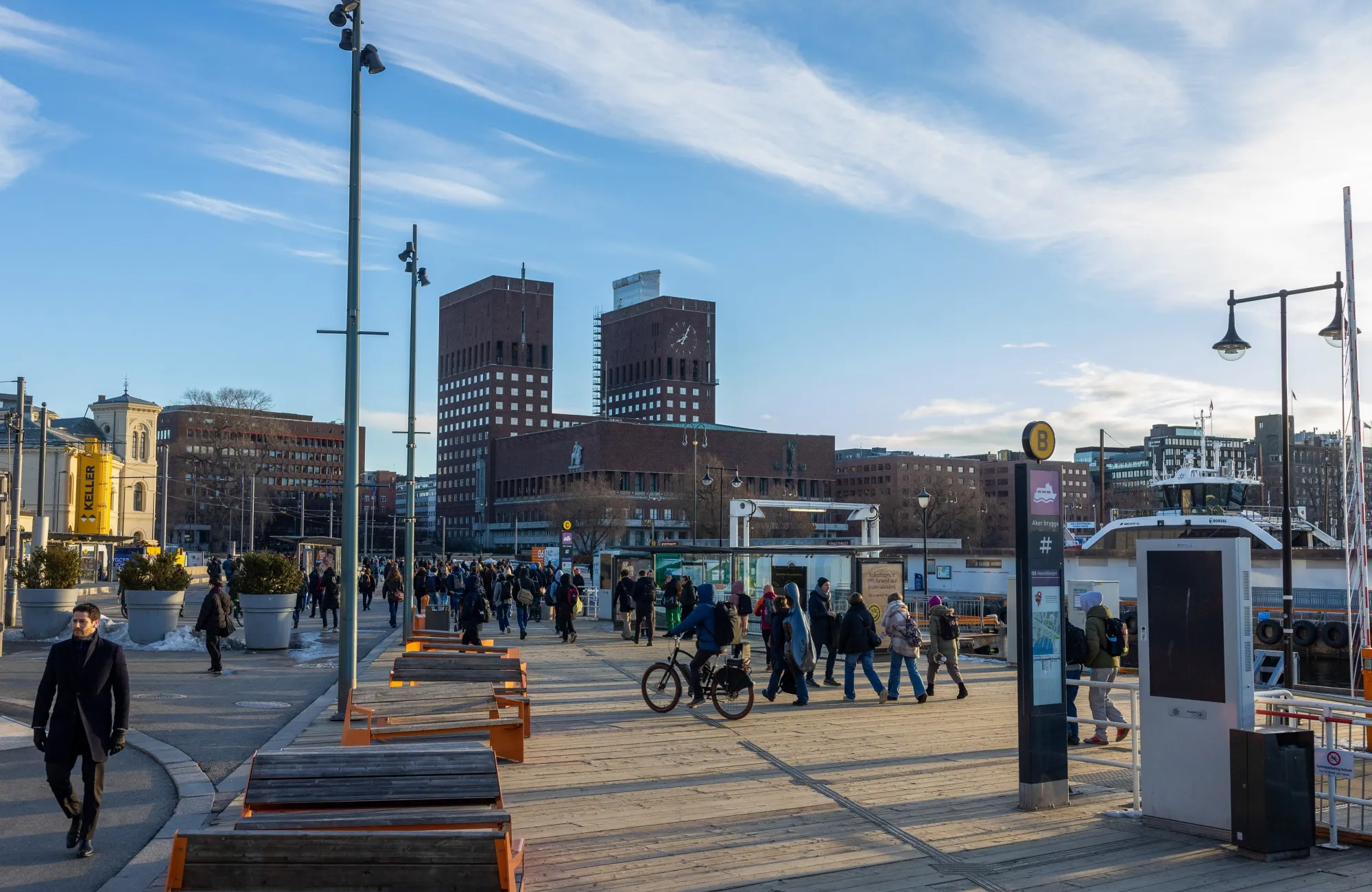 Commuters walk along the dockside near Oslo City Hall, the site of the Nobel Peace Prize ceremony, on March 6, 2023.