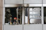 Firefighters stand on a floor at a building where a fire broke out in Osaka on Dec. 17.