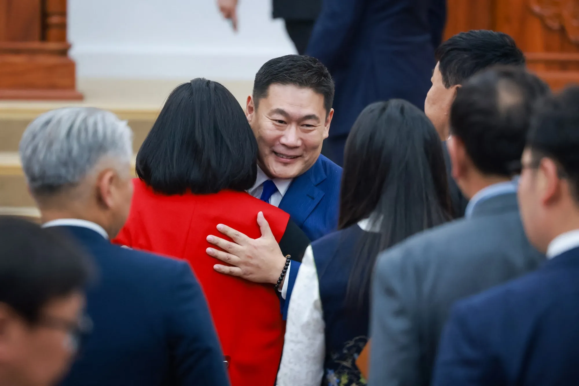 Oyun-ErdeneLuvsannamsrain hugs members of parliaments after a vote in Ulaanbaatar on June 3.