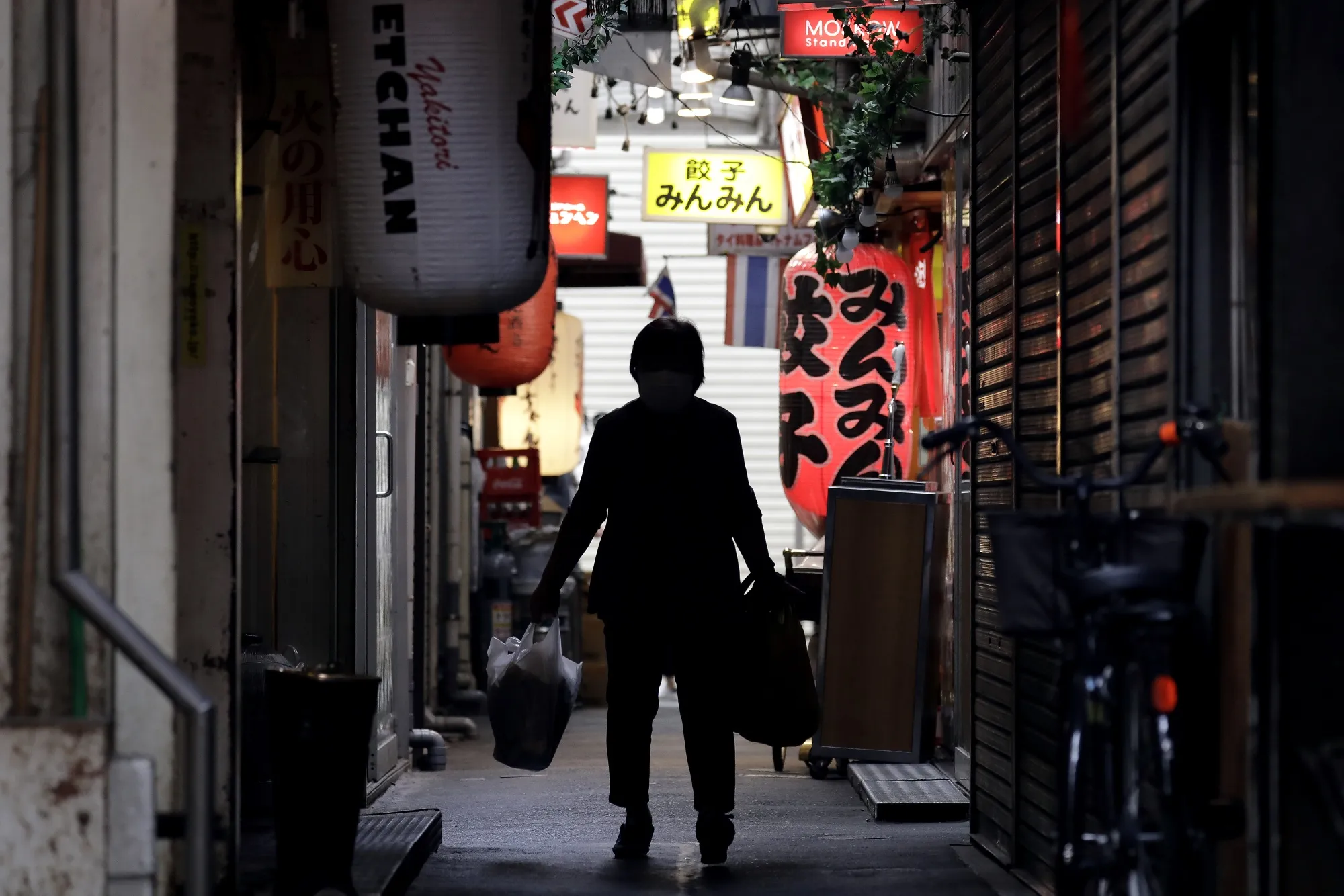 A shoper walks through an alley in the Kichijoji area of Tokyo on May 26.