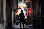 A shoper walks through an alley in the Kichijoji area of Tokyo on May 26.