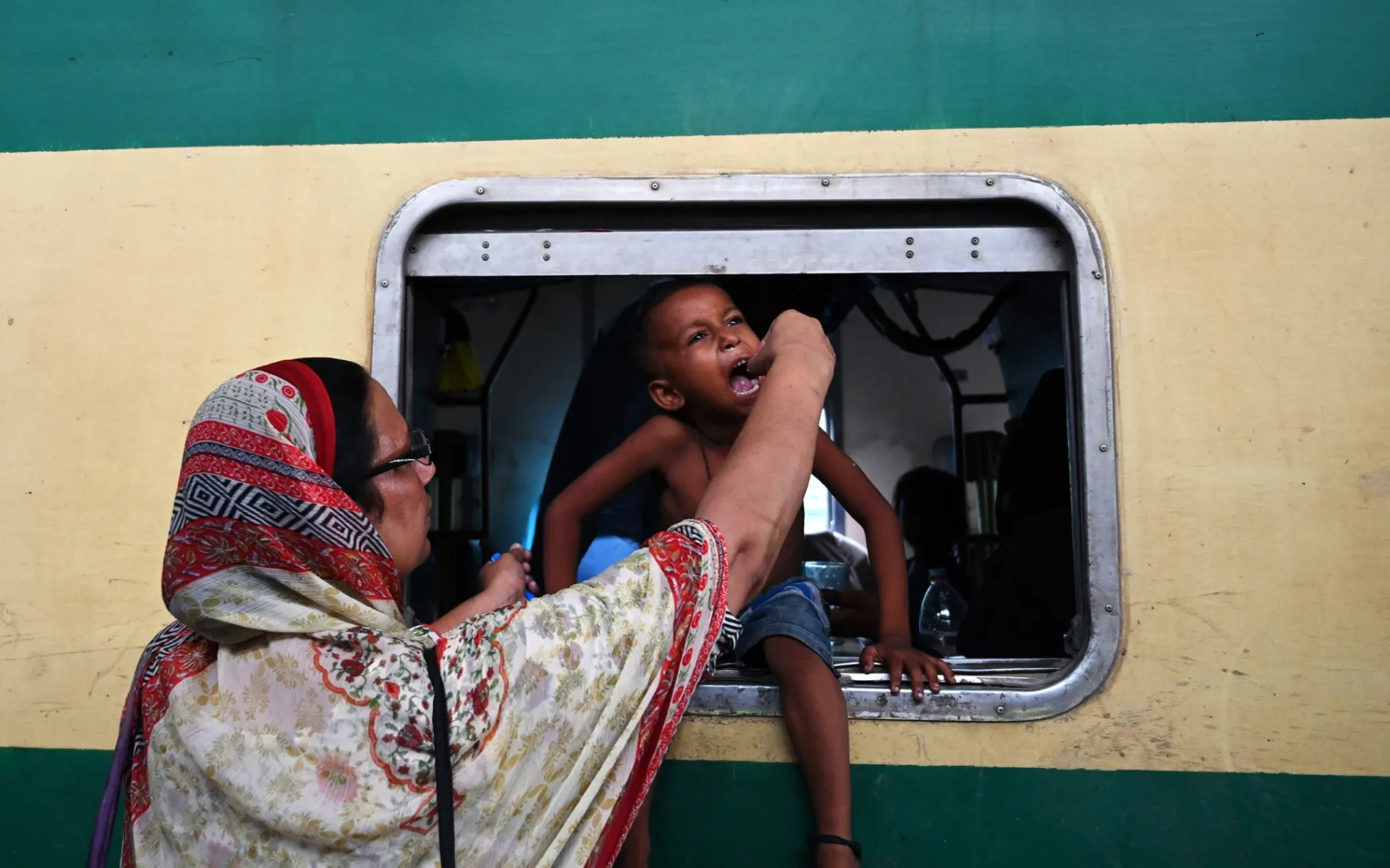 A health worker administers a polio vaccine to a child in Lahore.