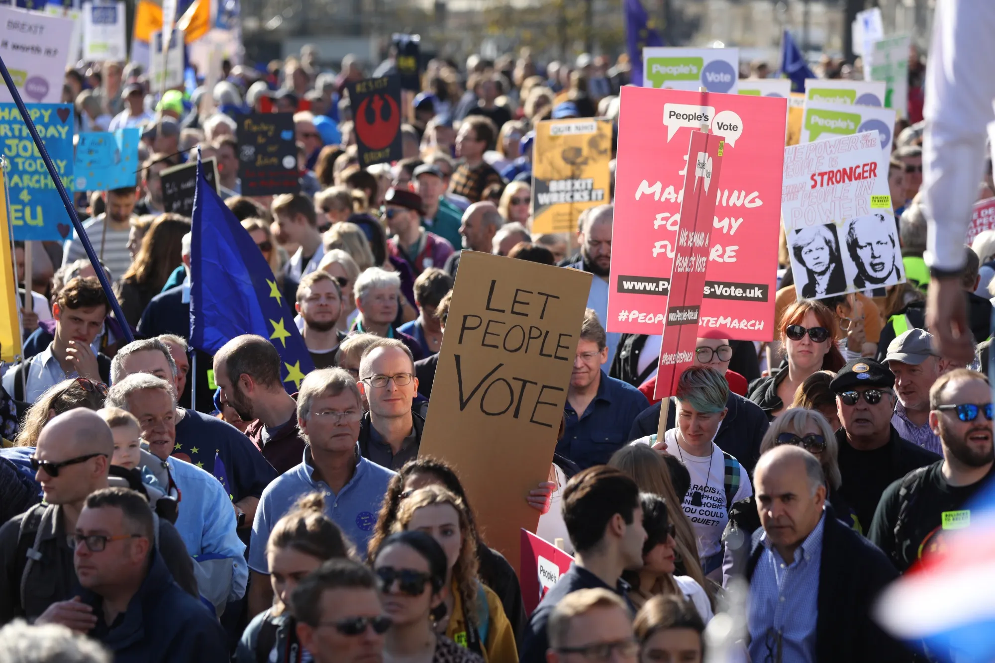 Demonstrators hold signs and flags during the anti-Brexit People's Vote march, in London&nbsp;on&nbsp; Oct. 20.
