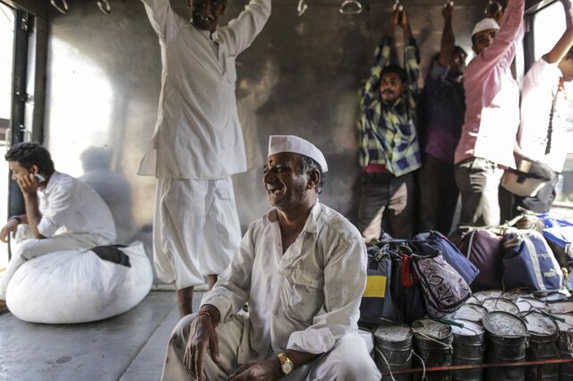 A dabbawala transports a crate of tiffin boxes by train in 2015. Dabbawalas have been delivering Mumbai office workers their lunches for over 130 years.