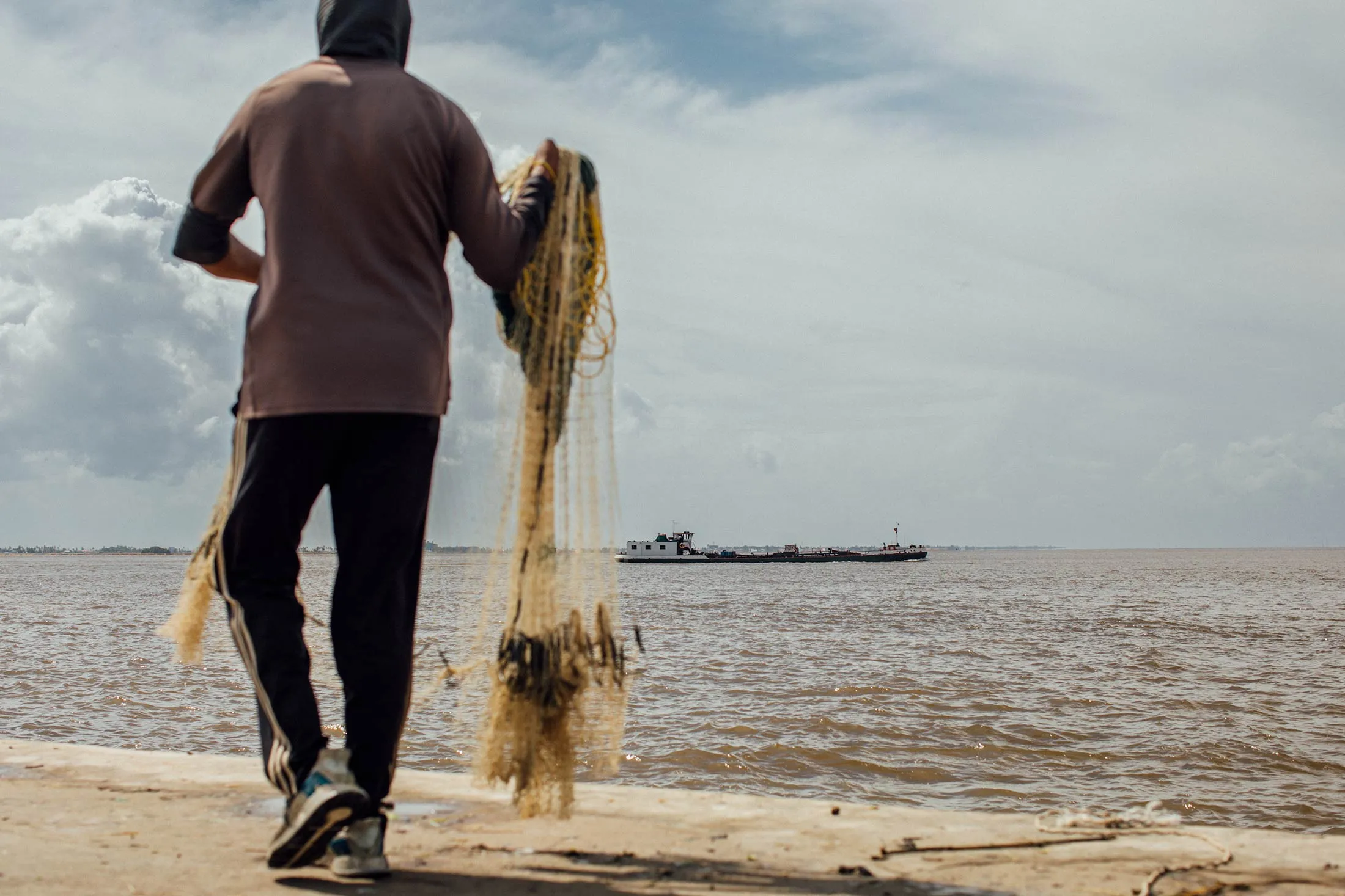 A fisherman at the seawall in Georgetown, Guyana.