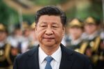 China's President Xi Jinping reviews a military honour guard during a welcome ceremony at the Great Hall of the People in Beijing on December 12, 2018.