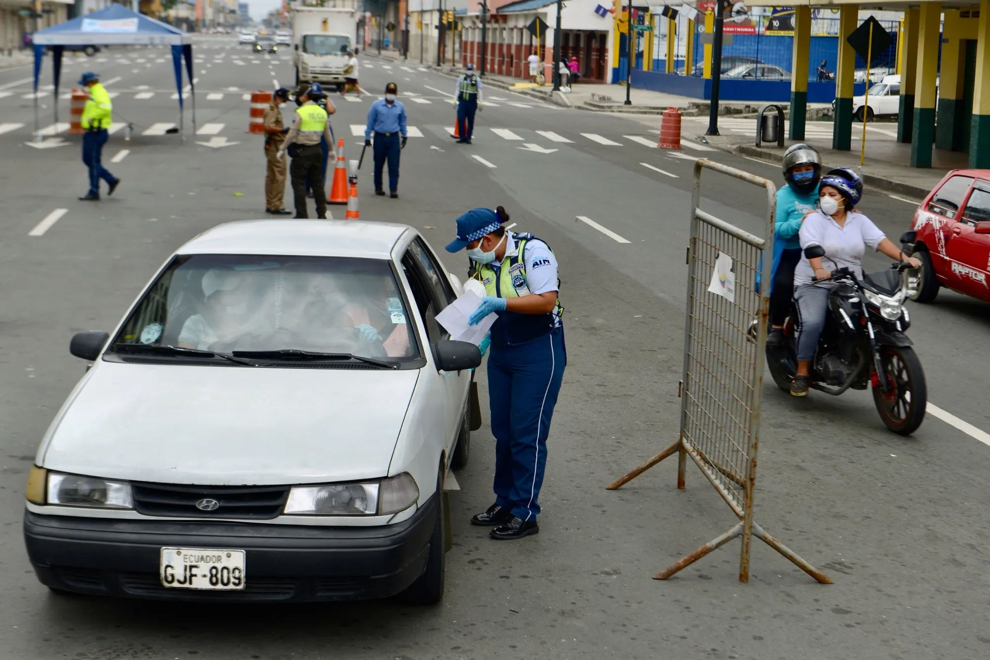 A police officer checks a vehicle in Guayaquil on April 9.