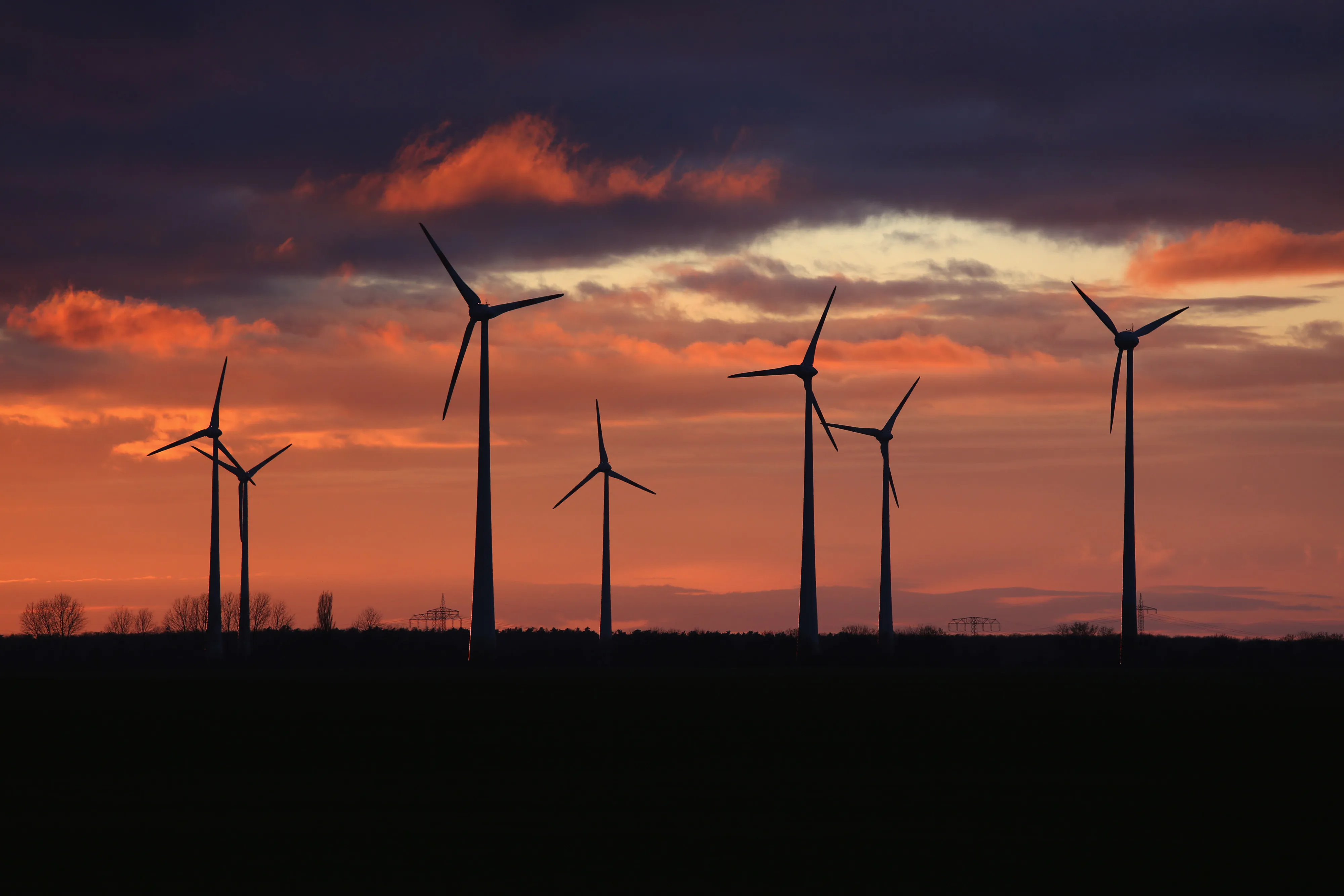 Wind turbines at a wind farm during sunset in Nauen Brandenburg, Germany, on Wednesday, Dec. 30, 2020. It was a pivotal year in the transition toward renewable energy, underpinned by massive government spending pledges and corporations working to burnish their environmental, social and governance credentials.