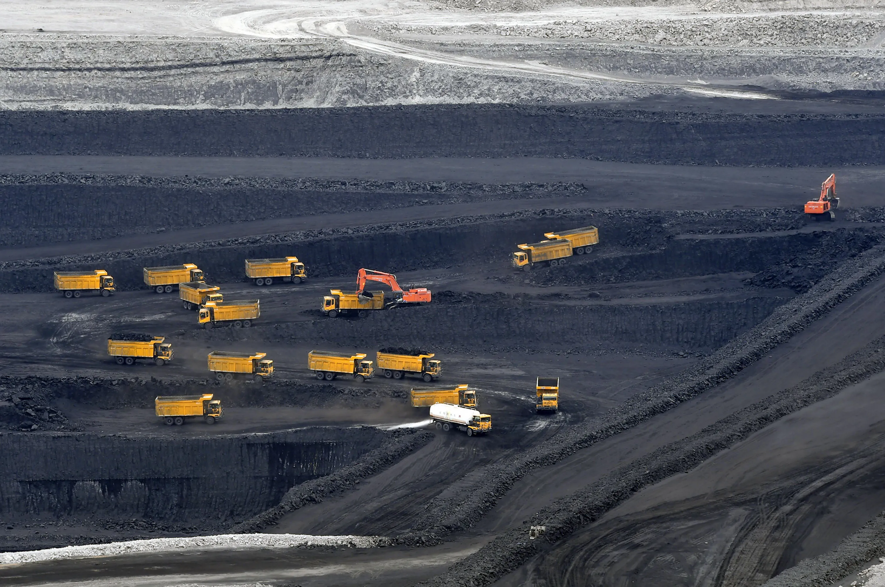 Transport trucks transfer raw coal in pits&nbsp;in Changji Hui Autonomous Prefecture, China.&nbsp;