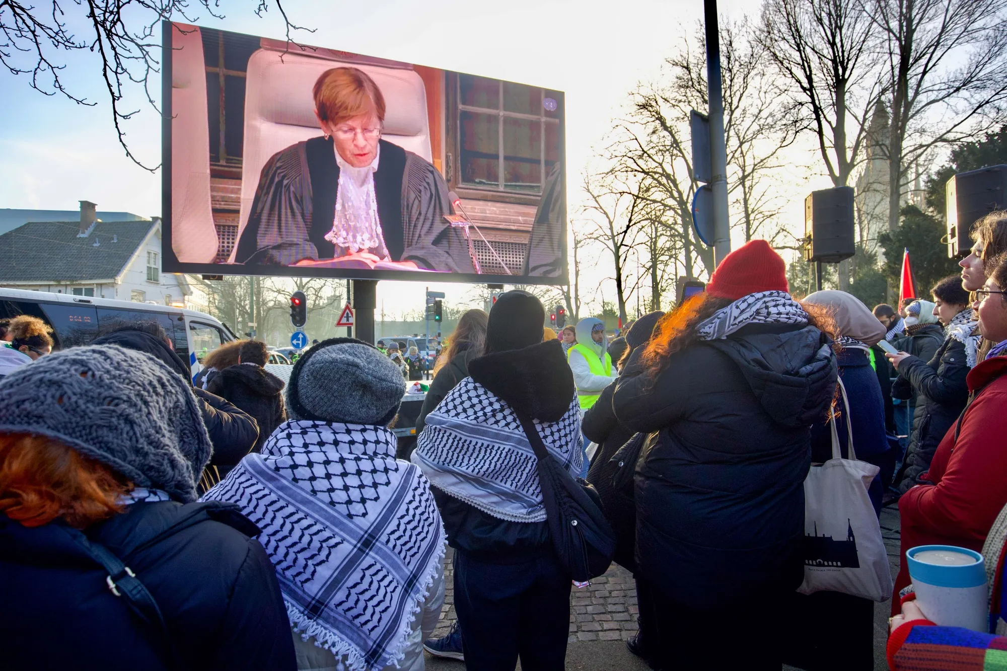 Pro-Palestinian demonstrators watch proceedings at the International Court of Justice in The Hague on Jan. 11.