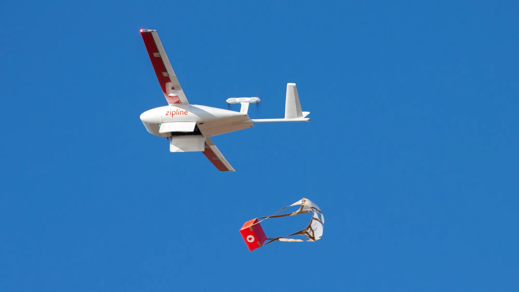 A Zipline drone drops its payload.