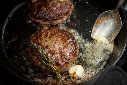 When using a skillet, constantly baste a mixture of butter, garlic, and thyme over the burger until it's ready.