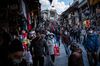 People shop on a busy market street in Istanbul on April 9. 