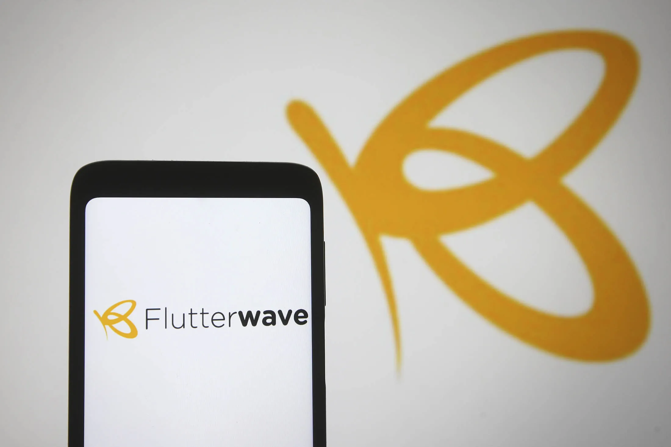 In this photo illustration the Flutterwave logo of a