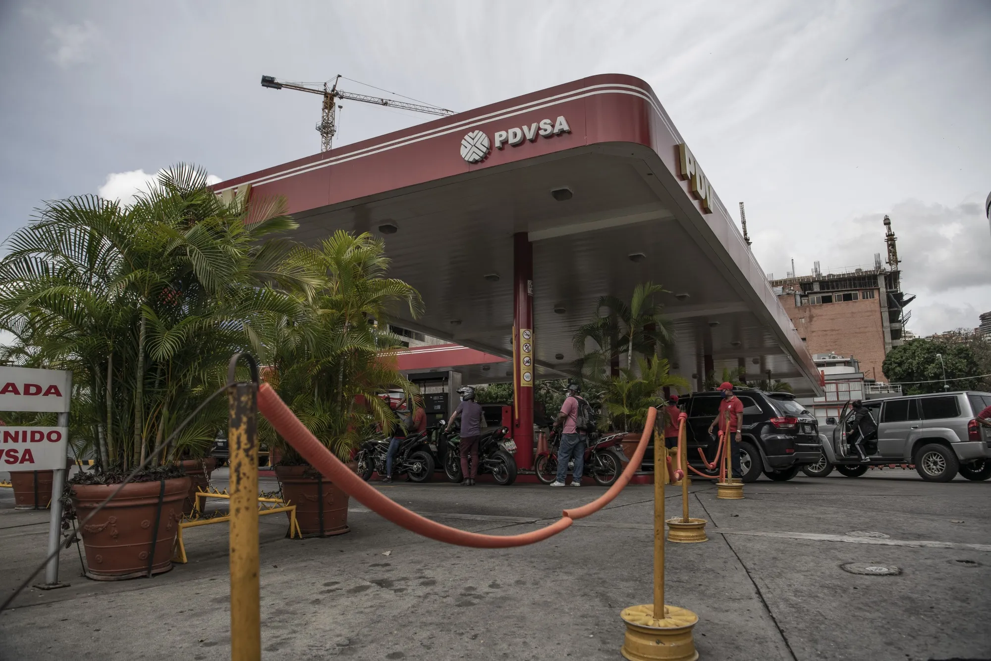 Vehicles wait in line to refuel at a Petroleos de Venezuela SA (PDVSA) gas station in Caracas, Venezuela.