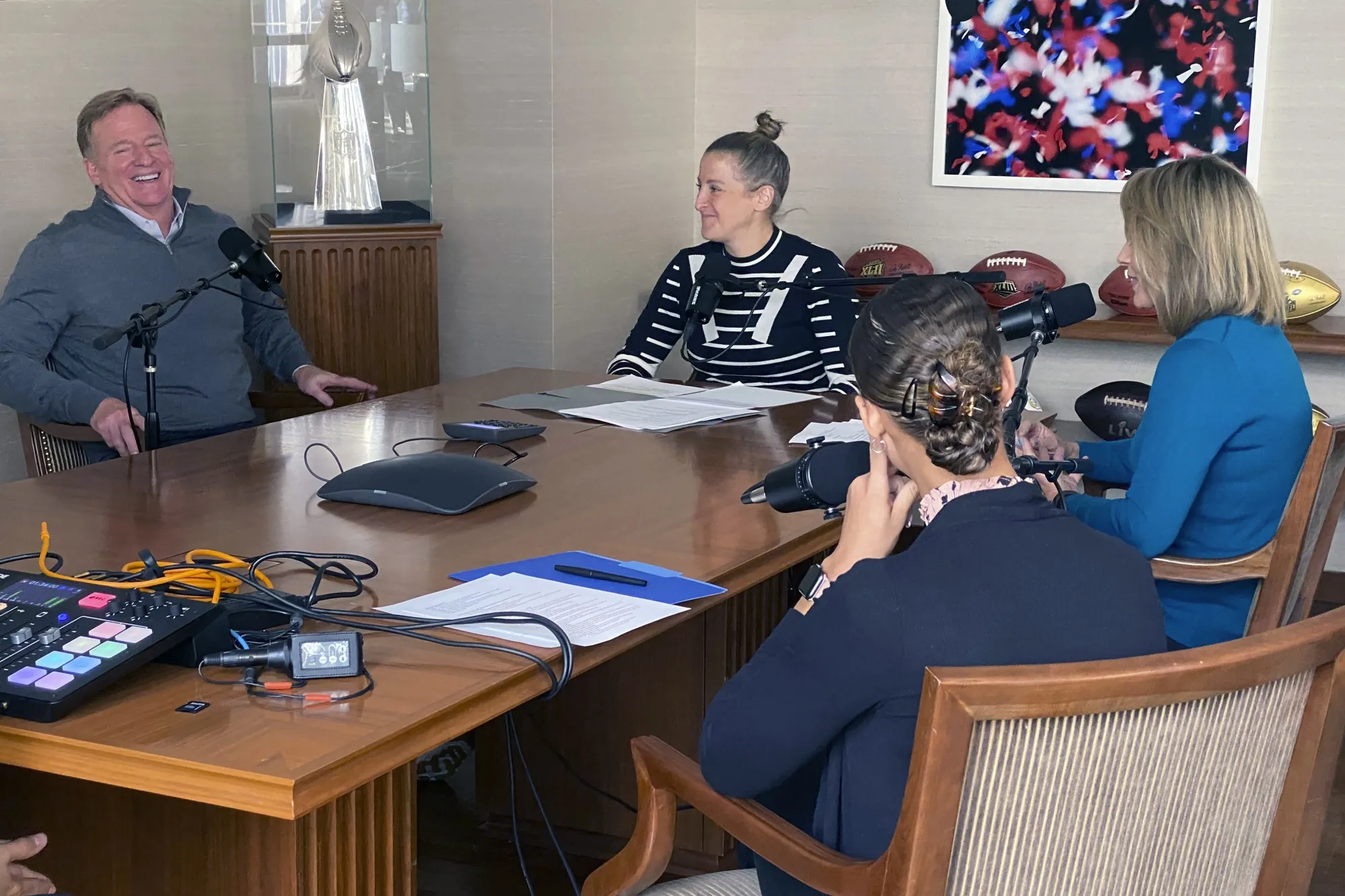 This photo provided by the NFL shows NFL commissioner Roger Goodell laughing while meeting with Sam Rapoport, center left, the league's senior director of diversity, equity and inclusion, Jane Goodell, right, and  Venessa Hutchinson, foreground, senior manager of football operations for the NFL in New York on Aug., 27, 2021. For decades, the road to the NFL for women has been filled with obstacles. It’s begun to open up in recent years, and the stories need to be told. Which leads to Sam Rapoport and “Earnin’ It: The NFL’s Forward Progress,′ a podcast launching Tuesday, Nov. 9.(NFL via AP)