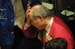 A tired trader works on his final trades of the day at the New York Stock Exchange on February 16, 2001.