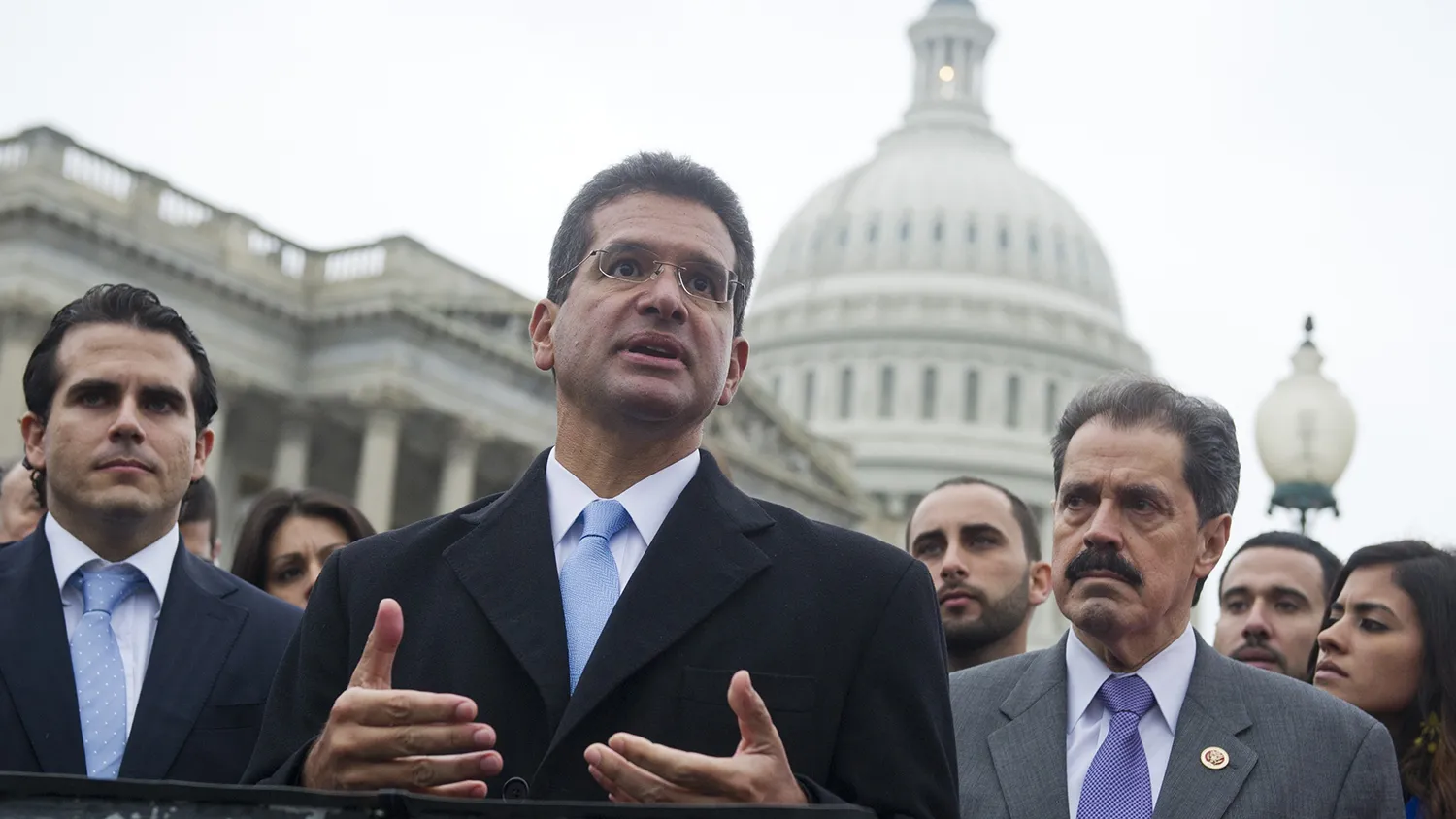 Resident Commissioner Pedro Pierluisi (C) of Puerto Rico speaks alongside US Representative Jose Serrano (R), Democrat of New York, and Puerto Rican activists, urging Congress to allow an end to the island's territorial status, during a press conference at the US Capitol in Washington, DC, on January 15, 2013.
